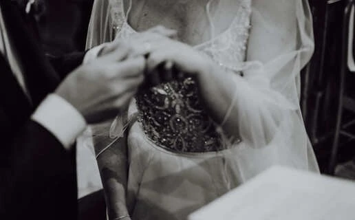 Dettaglio delle mani dello sposo mentre inserisce la fede nella mano della sposa durante la cerimonia in chiesa. Fotografo di Matrimoni a Cuneo, matrimonio a Cuneo