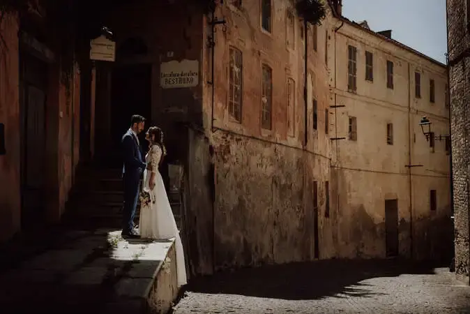 Coppia di sposi che si tiene per mano durante la sessione fotografica di coppia. Matrimonio a Mondovì. Fotografo di matrimonio a Cuneo.